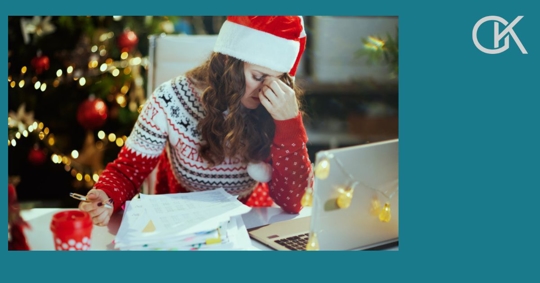 stressed woman looking at documents at Christmas